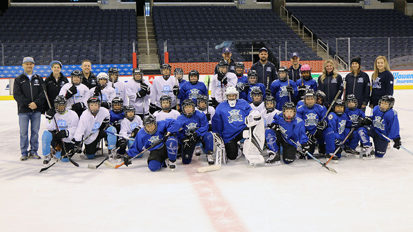 Group photo on ice of WJHA and ICE Program kids