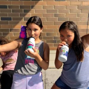 Two ICE Program kids drinking out of water bottles