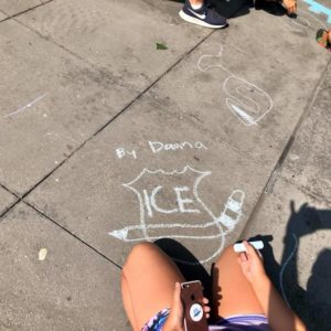 Kid drawing of ICE logo on sidewalk