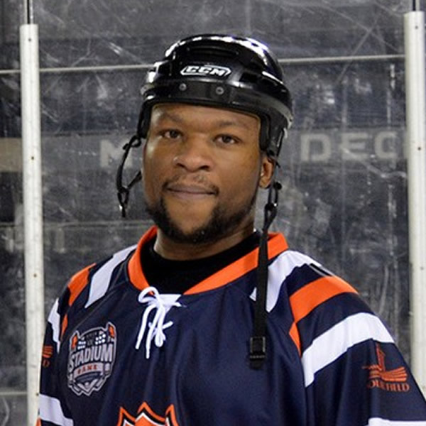 Photo of Darius Mack in hockey jersey at rink